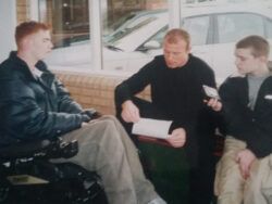 A young Alan share being interview by two NUDSA members.
