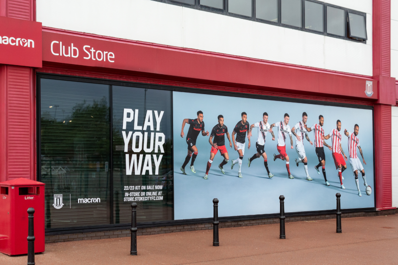 The image shows the Stoke City club store, with first-team players modelling the three new interchangeable strips.
